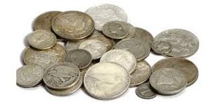 A pile of silver coins sitting on top of each other.